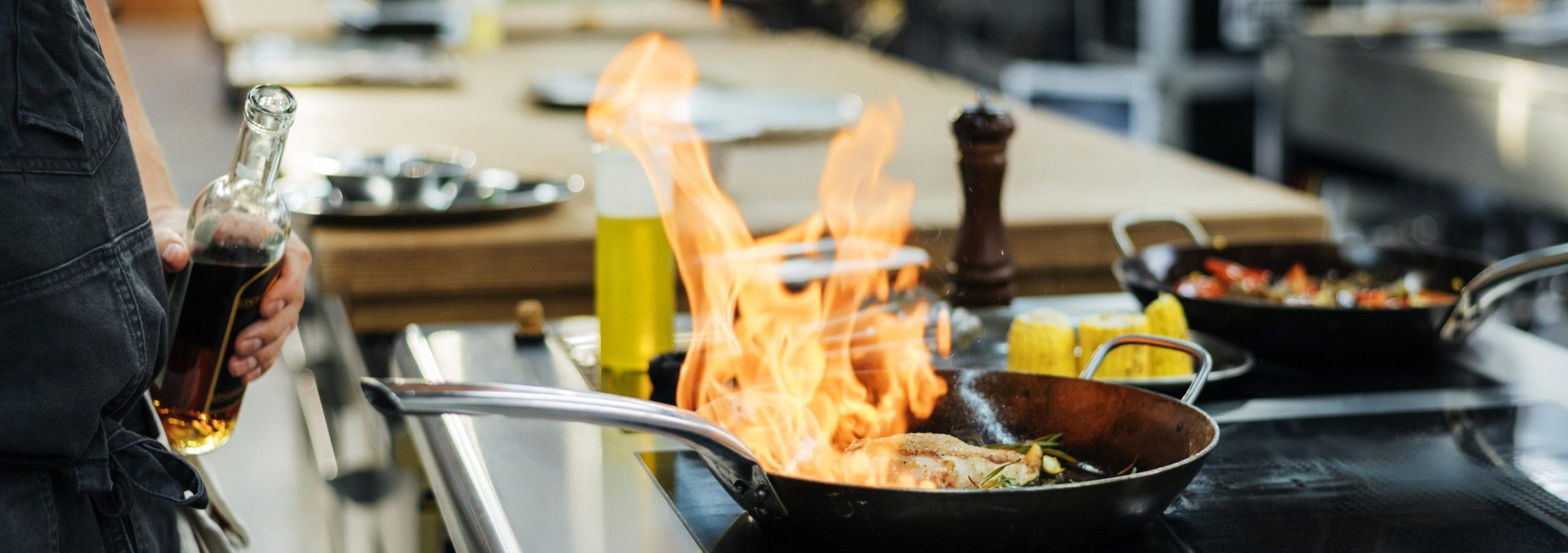 side-view-chef-flambeing-dish-kitchen